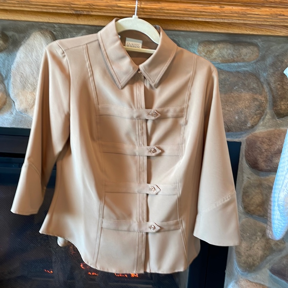 This is more like a casual jacket, more than a top.  Polyester and spandex.